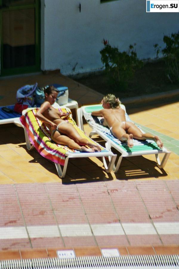 Girls sunbathe topless near the pool. Photo 13