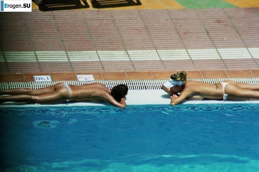 Girls sunbathe topless near the pool. Photo 27
