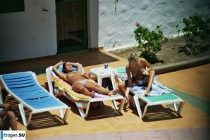 Girls sunbathe topless near the pool. Thumb 28
