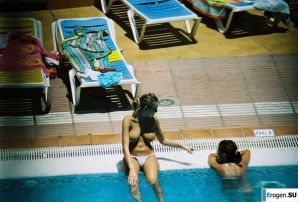 Girls sunbathe topless near the pool. Thumb 8