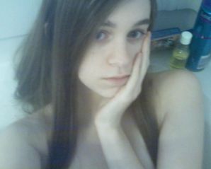 Brunette in revealing outfits and without anything. Thumb 24