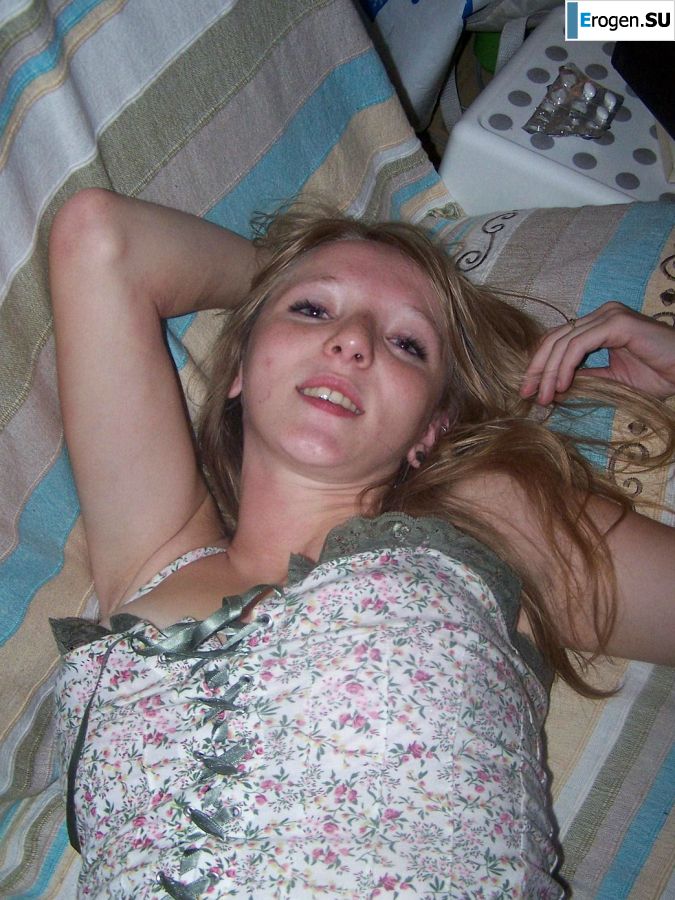 The red-haired beauty poses on the bed without panties, spread her legs. Slide 11